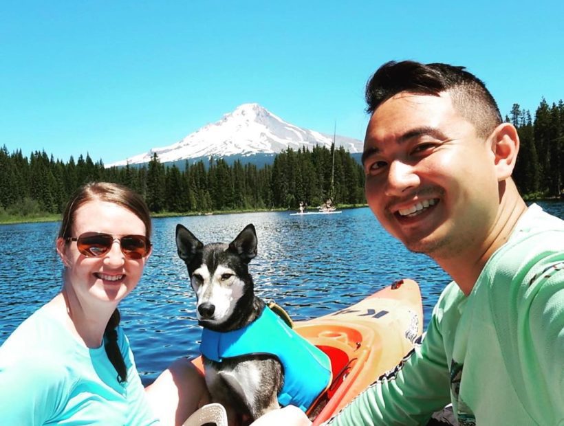 couple and dog kayaking on a lake